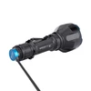 Powerful Olight Warrior X Turbo tactical flashlight charging via its magnetic tailcap cable.