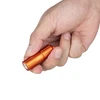 Person's hand holds a sleek orange metal mini flashlight, a compact and portable LED light for everyday use.