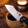 SENTRY RI 14C28N folding knife with cleaver blade, black handle, wooden bowl, warm lantern.