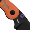 Close-up of a Halloween themed pocket knife featuring an orange handle with a bat inlay, black blade, and purple thumb stud.