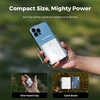 Hand holding a Flextail compact air pump next to a smartphone showing its card-sized dimensions.