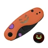 Orange Halloween pocket knife with purple accents and a glow-in-the-dark jack-o-lantern face on the handle