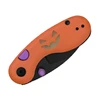 Orange Halloween folding pocket knife with pumpkin jack-o-lantern face handle design and purple accents on white background