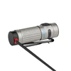 Silver Olight Baton 4 textured EDC flashlight, with clip, magnetically charging via its tailcap.