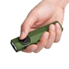 Olight green ArkPro flashlight held in hand with side button for everyday carry and outdoor use.
