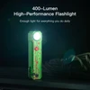 Bright green 400-lumen high-performance flashlight with red splatter design shining in the dark.