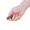 Hand holding ultra compact bronze Olight EDC keychain flashlight showing portable miniature size