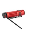 Olight Warrior Nano red compact tactical flashlight charging with magnetic MCC cable on white background