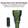 Green flashlight with remote control charging magnetically on its side, ensuring it's always ready for use.