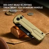 Gold TC4 titanium handle pocket knife with 400-grit bead blasting treatment on brown canvas background