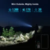 Olight BATON 4 Flashlight Side View with Powerful Beam Illuminating a Night Landscape for Outdoor Adventures