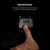 Hand pressing the dedicated NV button on a tactical red dot sight to switch between daylight and night vision modes.