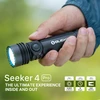 Olight Black Seeker 4 Pro flashlight held in hand, showing bright light and textured body for outdoor use.